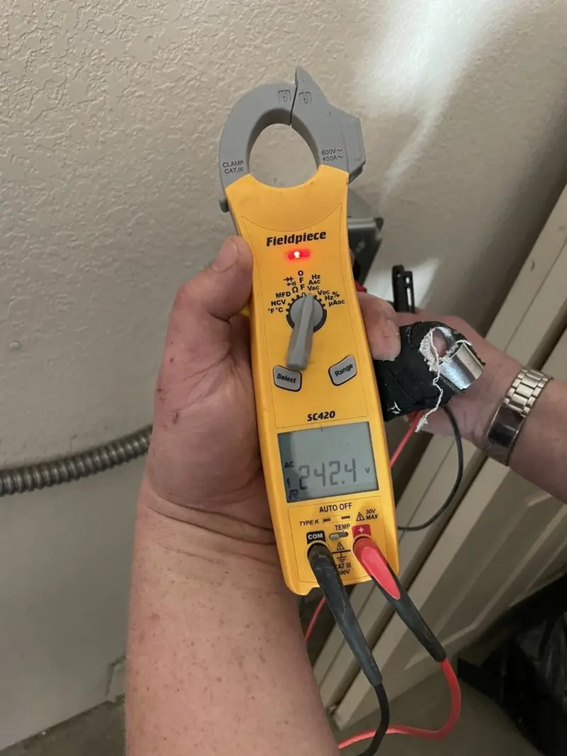 Voltage testing with clamp meter during Electrical Installation Services in Pea Ridge